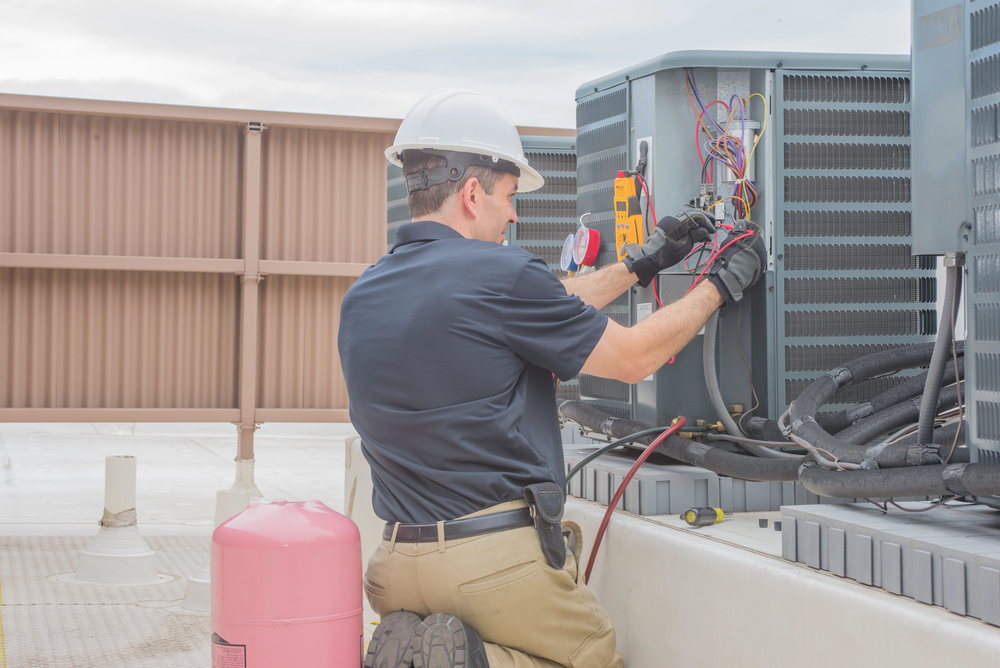 Technician performing HVAC repair