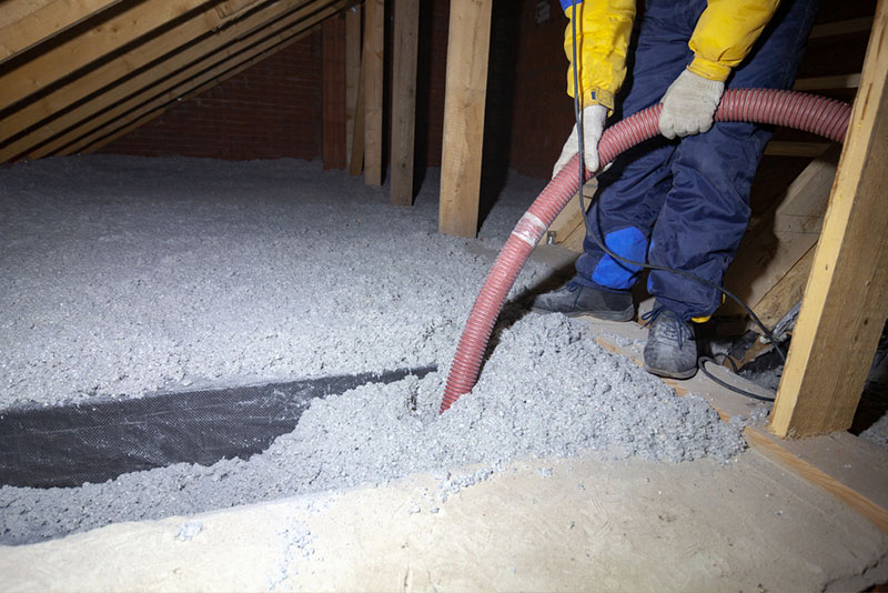 Spraying cellulose insulation in the attic