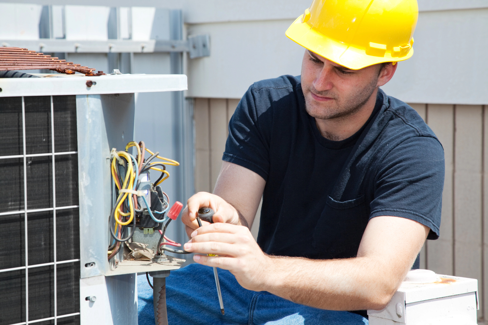 Man maintaining air conditioning system